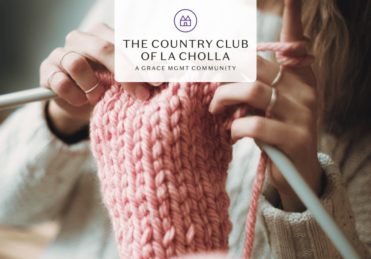 Close-up of hands knitting with thick pink yarn on a loom, featuring a translucent logo overlay for The Country Club of LA Cholla.