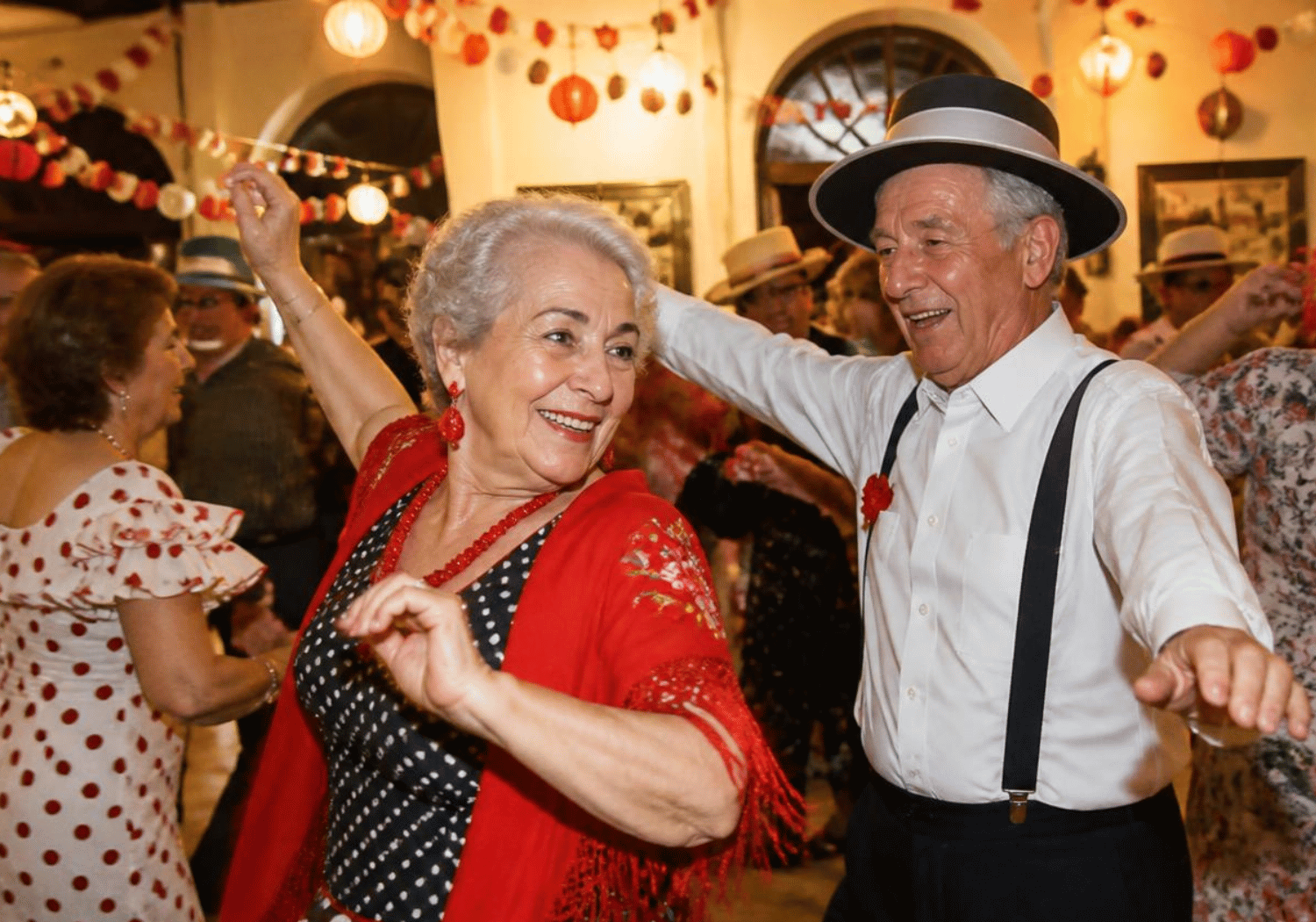 Older couple dancing together at a festive party, smiling as lights and colorful decorations glow in the background.